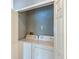 Convenient laundry closet with a white washer and dryer, neatly tucked behind bi-fold doors at 13829 Timberland Dr # 204, Orlando, FL 32824