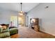 The living room features an open layout, carpeted floors, and sliding glass doors to the outside at 13829 Timberland Dr # 204, Orlando, FL 32824