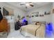 Cozy bedroom features a full size bed, TV, and custom decor at 13942 Jomatt Loop, Winter Garden, FL 34787