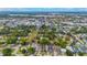 An aerial shot capturing the neighborhood with an open green space, set under a partially cloudy sky at 1545 Indiana Ave # B, Winter Park, FL 32789