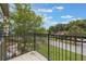 View from the balcony overlooking the neighborhood with green grass and blue skies at 1545 Indiana Ave # B, Winter Park, FL 32789