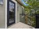 Exterior view of balcony with black metal railings, an outdoor light fixture, and a glass door at 1545 Indiana Ave # B, Winter Park, FL 32789