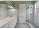 Bathroom with herringbone floors, marble vanity, and glass shower with marble walls at 1545 Indiana Ave # B, Winter Park, FL 32789