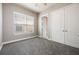 Bedroom with gray carpet, neutral walls, window, and double-door closet at 1545 Indiana Ave # B, Winter Park, FL 32789