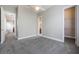 Bedroom featuring gray carpet, ceiling fan, access to bathroom and walk in closet at 1545 Indiana Ave # B, Winter Park, FL 32789