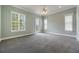 Bright bedroom with three windows, carpet, and a ceiling fan at 1545 Indiana Ave # B, Winter Park, FL 32789