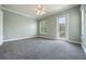 Bedroom featuring a ceiling fan, neutral carpet, and access to the balcony at 1545 Indiana Ave # B, Winter Park, FL 32789