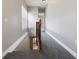 Second-floor hallway featuring carpet, wood railing, and neutral paint at 1545 Indiana Ave # B, Winter Park, FL 32789