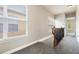 Second-floor hallway featuring carpet, wood railing, and neutral paint at 1545 Indiana Ave # B, Winter Park, FL 32789