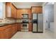 Traditional kitchen with wood cabinets, stainless steel appliances, and tile backsplash at 1545 Indiana Ave # B, Winter Park, FL 32789