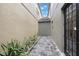 Narrow stone paver patio with plants and outdoor access between two houses at 1545 Indiana Ave # B, Winter Park, FL 32789