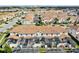 An aerial view shows a community with many residences, some of which have private, screened-in pools and tile roofs at 1554 Plunker Dr, Davenport, FL 33896