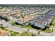 An aerial view of residences in a community, where some houses are showing private swimming pools in screened lanais at 1554 Plunker Dr, Davenport, FL 33896