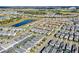 Wide aerial photograph of a residential area, showing organized streets, well-kept homes, and a picturesque lake at 1554 Plunker Dr, Davenport, FL 33896