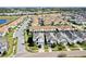Aerial view shows the community with houses with different roof colors, a lake, golf course, and other Florida communities at 1554 Plunker Dr, Davenport, FL 33896
