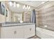 Bright bathroom offers dual sinks, granite counters, ample lighting, and a separate shower and bathtub for a spa-like experience at 1554 Plunker Dr, Davenport, FL 33896