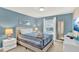 Serene bedroom with plush carpet, large window, and modern decor offers a tranquil and comfortable living space at 1554 Plunker Dr, Davenport, FL 33896