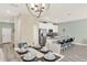 Bright dining area next to a kitchen with white cabinets and stainless appliances at 1554 Plunker Dr, Davenport, FL 33896