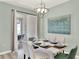 Dining room showcasing a modern chandelier and sliding glass door access to the patio at 1554 Plunker Dr, Davenport, FL 33896