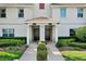 Close-up of condo entrances shows tidy front landscaping and walkway at 1554 Plunker Dr, Davenport, FL 33896