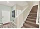 Entryway with tile floor, art, staircase, and white front door at 1554 Plunker Dr, Davenport, FL 33896