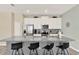 Kitchen with island, breakfast bar, stainless appliances, and white cabinets at 1554 Plunker Dr, Davenport, FL 33896