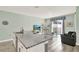 Kitchen island with granite countertops opens to the living area and patio doors at 1554 Plunker Dr, Davenport, FL 33896