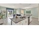 Open-concept kitchen features granite countertops, stainless steel appliances, and seamless flow to the living area and pool at 1554 Plunker Dr, Davenport, FL 33896