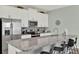 Well-equipped kitchen features stainless steel appliances, granite countertops, white cabinets, and counter seating at 1554 Plunker Dr, Davenport, FL 33896