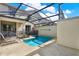 Private screened-in pool offers relaxation with lounge chairs and sunny patio at 1554 Plunker Dr, Davenport, FL 33896