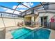 Private screened-in pool offers relaxation with lounge chairs and sunny patio at 1554 Plunker Dr, Davenport, FL 33896