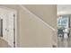 Staircase with a white railing adjacent to an archway leading into the dining room at 1554 Plunker Dr, Davenport, FL 33896