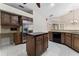 Bright kitchen with wood cabinets, granite counters, stainless fridge, and tile flooring at 1672 Wingspan Way, Winter Springs, FL 32708