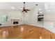 Bright living room with a fireplace, hardwood floors, skylight and breakfast bar into kitchen at 1672 Wingspan Way, Winter Springs, FL 32708