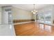 Bright dining room with hardwood floors, chandelier, and glass doors at 1672 Wingspan Way, Winter Springs, FL 32708