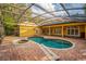 View of the screened in pool and spa from inside this house's patio at 1672 Wingspan Way, Winter Springs, FL 32708