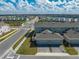 Aerial view of townhomes with two-car garages and community street view at 1860 Tohoqua Blvd, Kissimmee, FL 34744