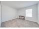 Simple bedroom with a modern desk, carpeted floors, and a bright window at 1860 Tohoqua Blvd, Kissimmee, FL 34744