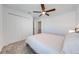 Simple bedroom featuring a ceiling fan, carpeted floors, and spacious closet at 1860 Tohoqua Blvd, Kissimmee, FL 34744