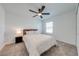 Bright bedroom showcasing a ceiling fan, window, and cozy queen-size bed at 1860 Tohoqua Blvd, Kissimmee, FL 34744