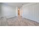 Well-lit bedroom featuring a closet, carpeted floors, and an ensuite bathroom entrance at 1860 Tohoqua Blvd, Kissimmee, FL 34744