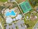 Aerial view showcases community pool, tennis court, playground, and manicured landscaping for residents' enjoyment at 1860 Tohoqua Blvd, Kissimmee, FL 34744