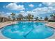 Beautiful community pool featuring clear blue water and plenty of lounge chairs for relaxing in the sun at 1860 Tohoqua Blvd, Kissimmee, FL 34744