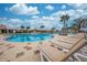 Community pool and lounge chairs with a clear view of the pool's recreational water features at 1860 Tohoqua Blvd, Kissimmee, FL 34744