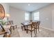 Bright dining room with a wooden table, chairs, modern decor, and natural light from two windows at 1860 Tohoqua Blvd, Kissimmee, FL 34744