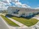 Exterior view of townhomes with well-manicured lawns and landscaping at 1860 Tohoqua Blvd, Kissimmee, FL 34744