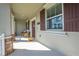 Inviting covered front porch with seating area and view of the front door with address at 1860 Tohoqua Blvd, Kissimmee, FL 34744