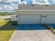 Two-car garage with brick driveway and well-maintained landscaping at 1860 Tohoqua Blvd, Kissimmee, FL 34744