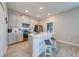 Open kitchen with island, bar stools, and stainless steel appliances at 1860 Tohoqua Blvd, Kissimmee, FL 34744