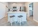 Kitchen with a large island, stainless steel appliances and view of the adjacent laundry room at 1860 Tohoqua Blvd, Kissimmee, FL 34744